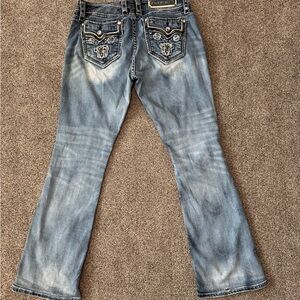 Rock Revival Boot Cut Women's Jeans. 1 small hole in back down by the hem area